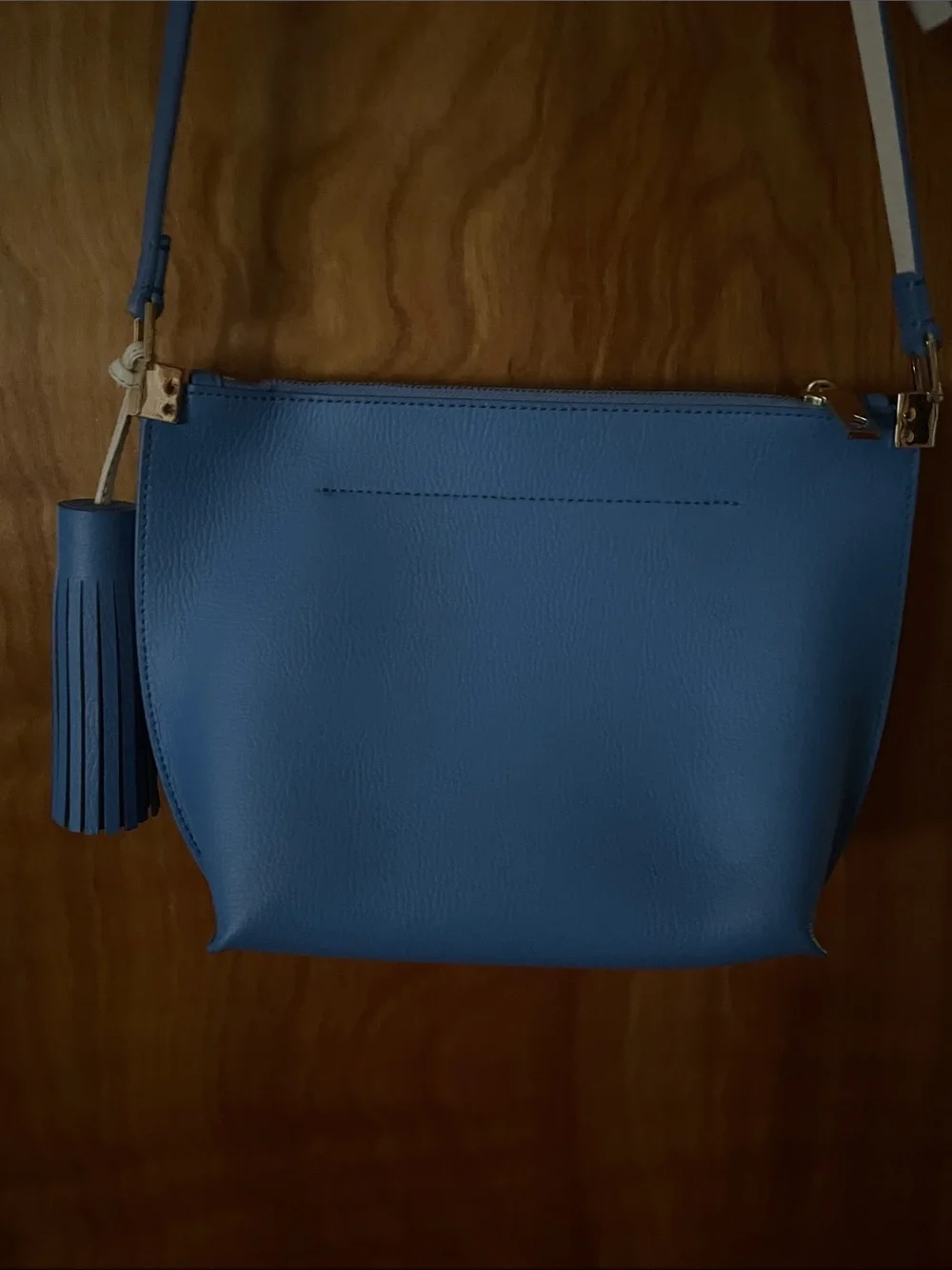 kate spade blue crossbody with cream strap and tassel